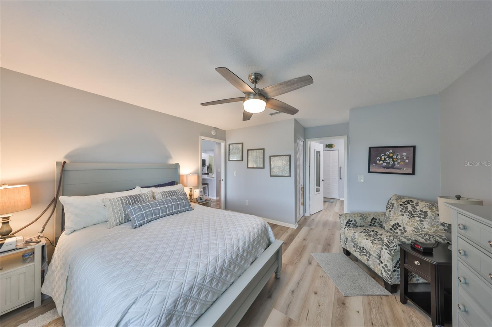 Again, soft neutral paint tones, continuous flooring and new light fixtures compliment this room which has an ensuite master bath.