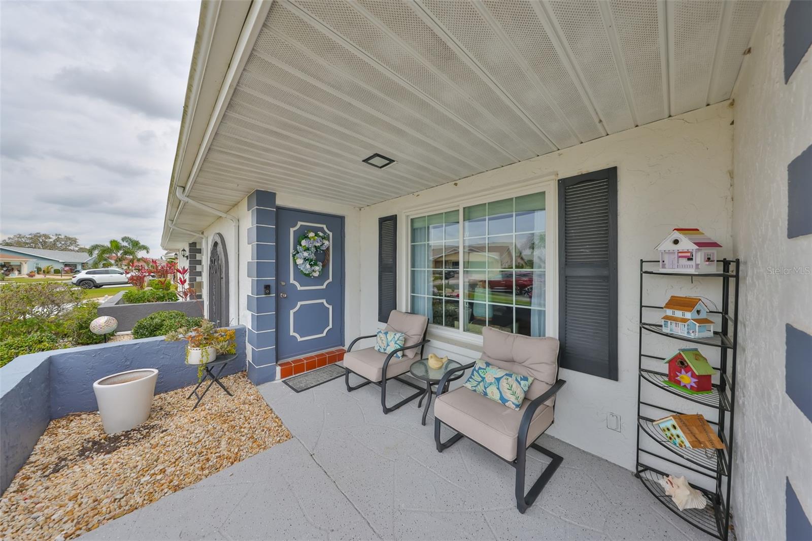 Front, open air, porch is perfect for visiting with the neighbors and staying out of the elements.