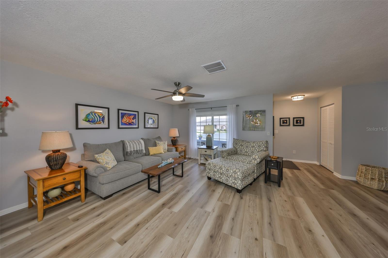 The living room is well lit with lots of space for entertaining.