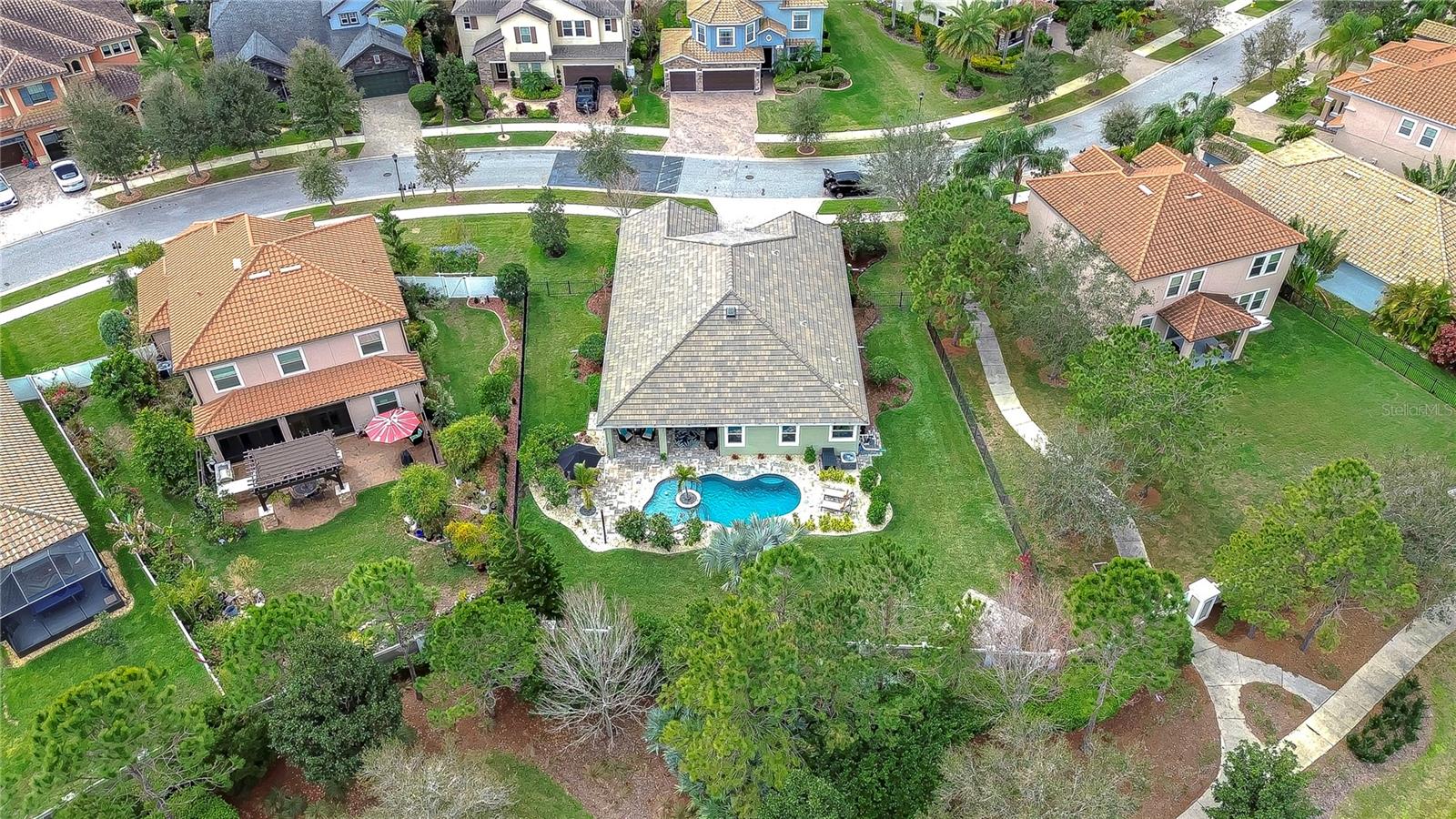 This exquisite home boasts a delightful backyard oasis with a charming pool.