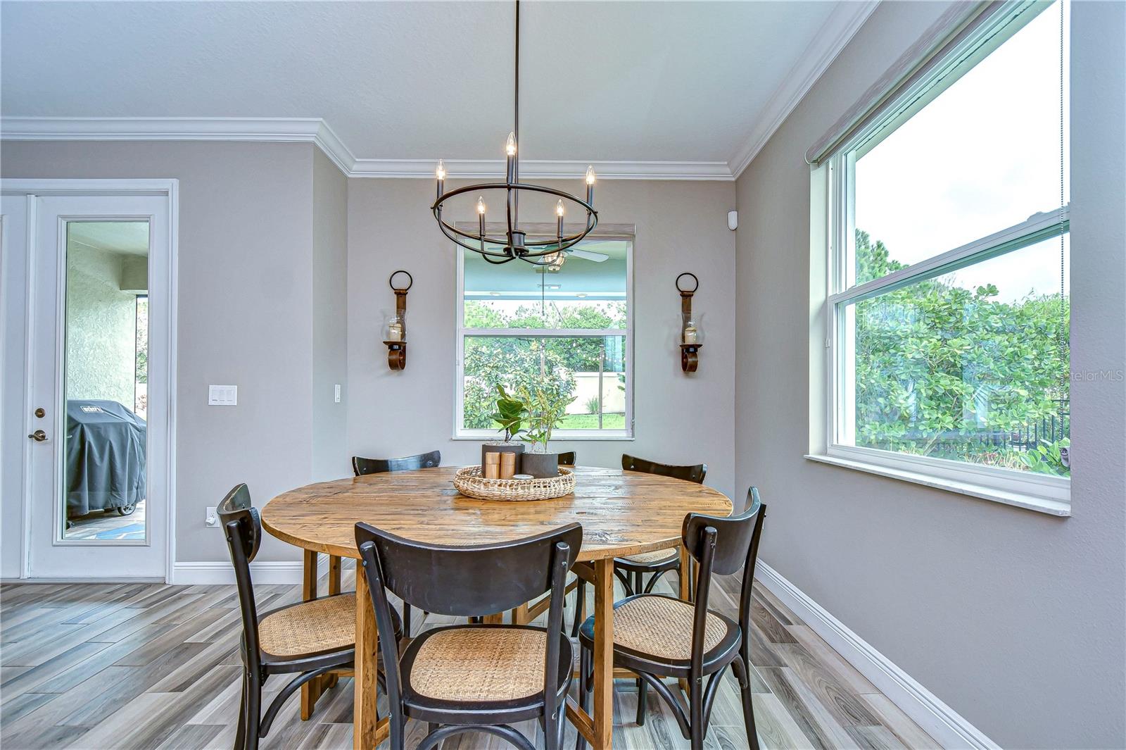 This additional dining area invites natural light through expansive windows.