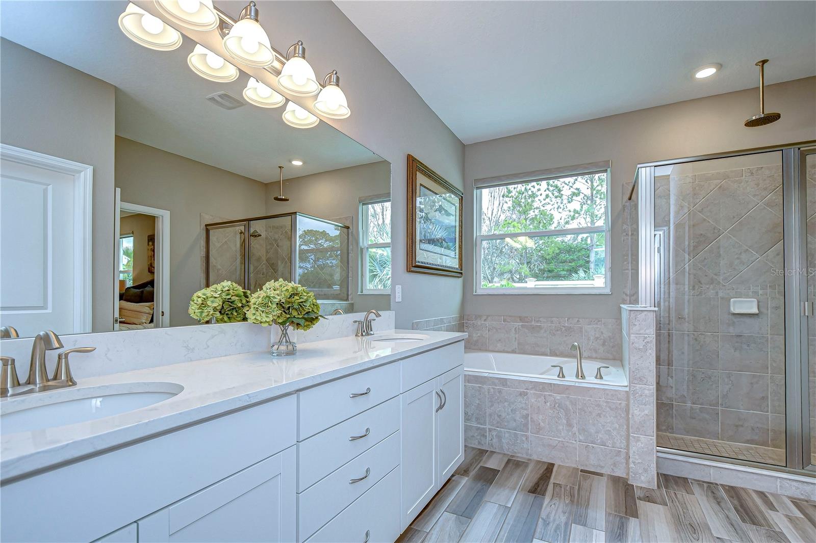 Relax in style in this luxurious primary bathroom with dual sinks and spacious shower.