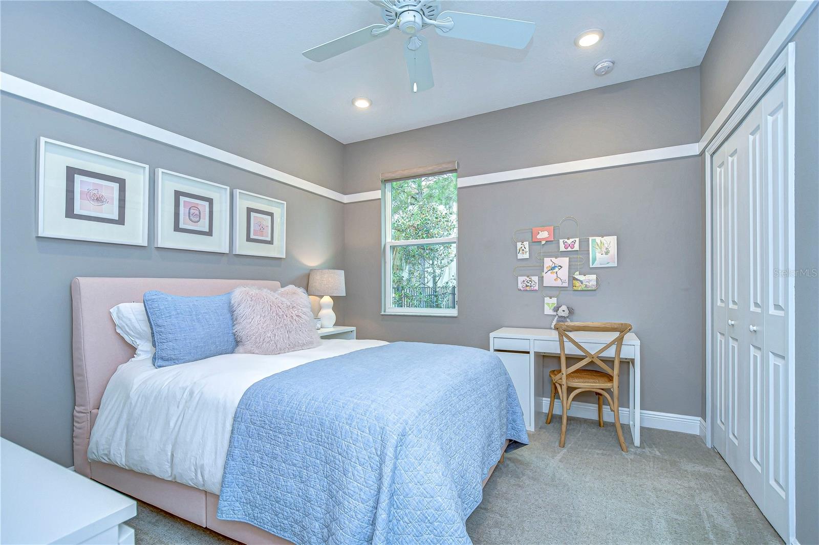 This charming second bedroom offers a cozy retreat with soft hues and elegant decor