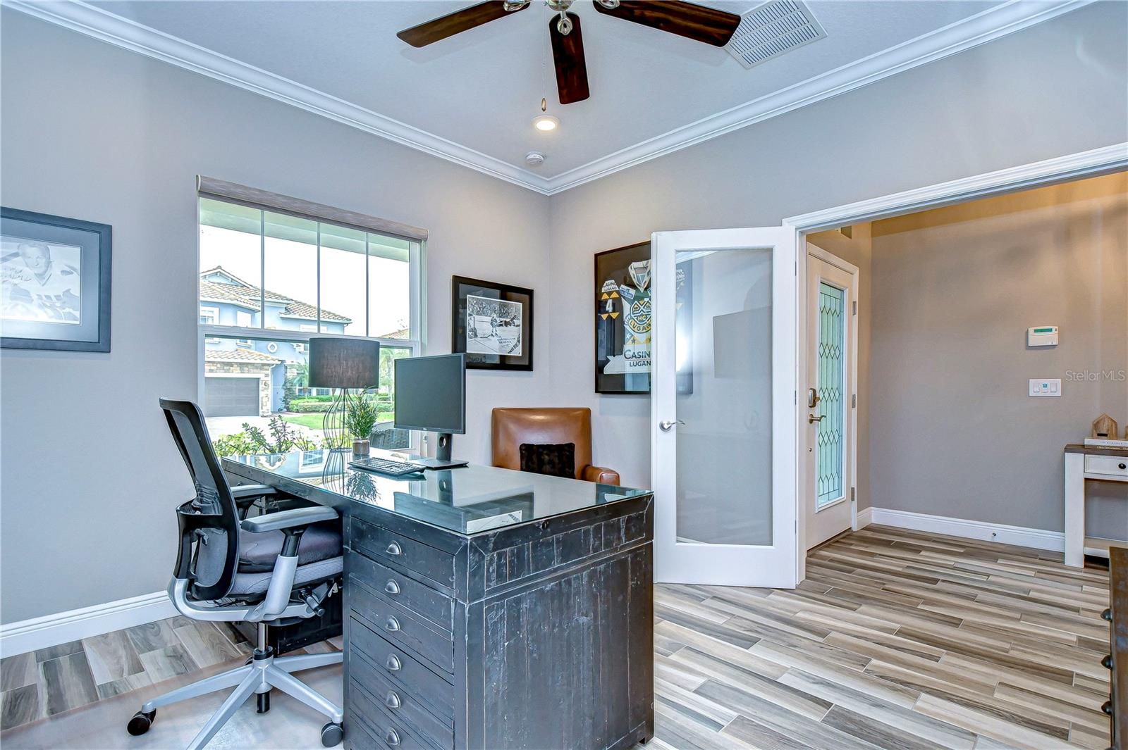 Beautiful French doors give access to this spacious office, highlighted by crown molding.