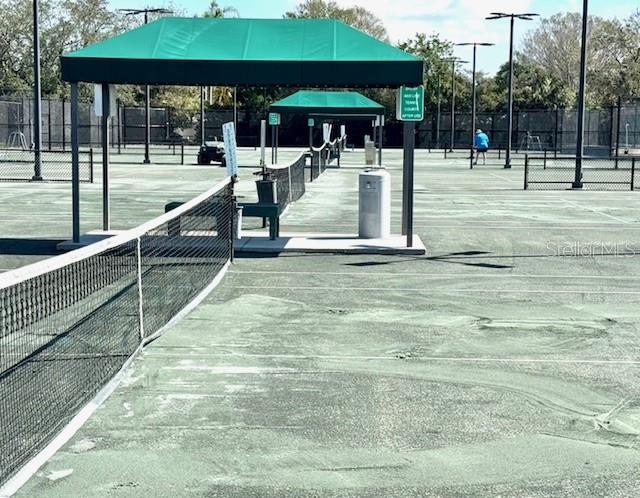 Composite/clay tennis surface undergoing maintenance