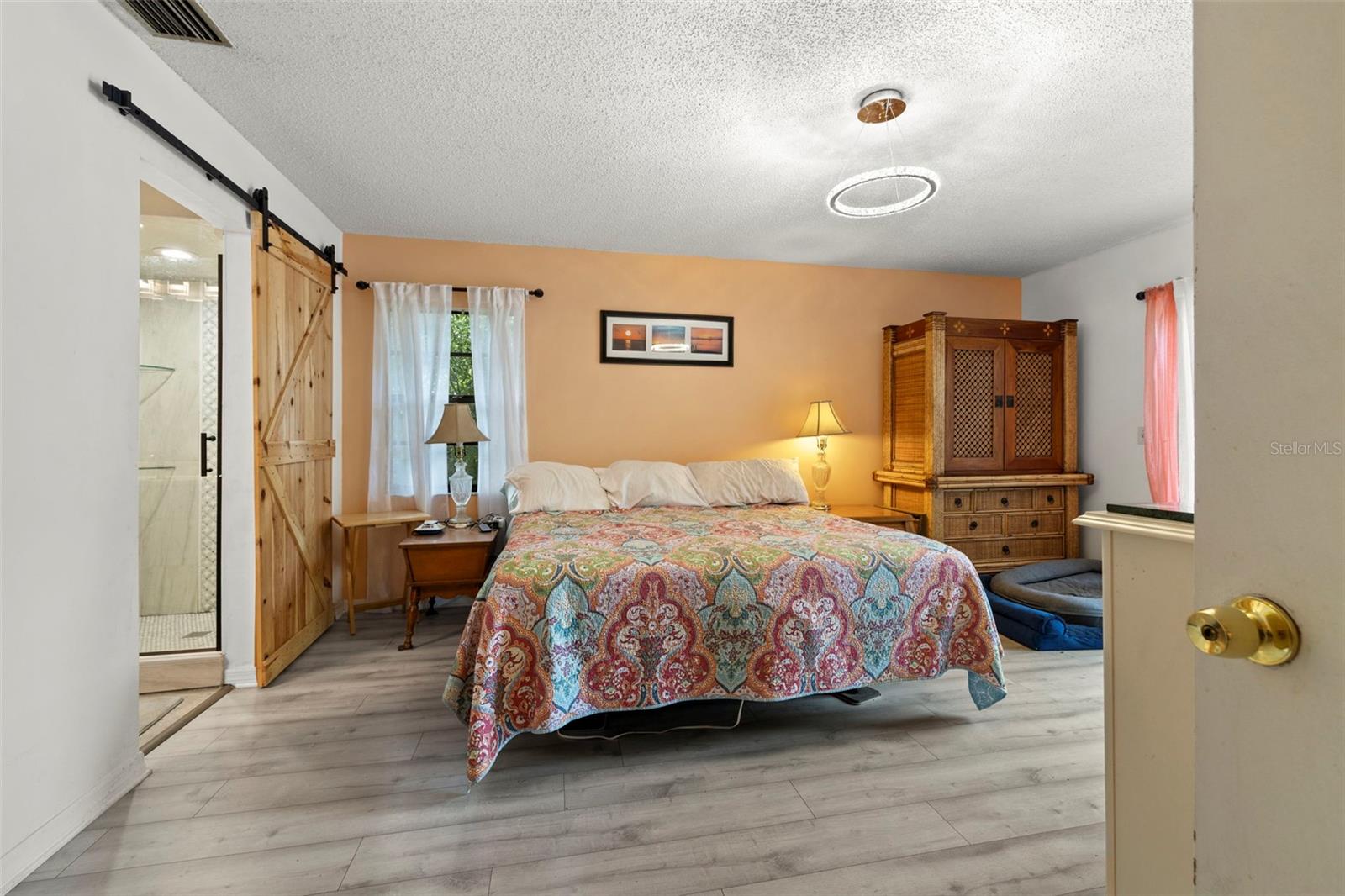 Primary Bedroom with Sliding Barn Door to Ensuite Bathroom