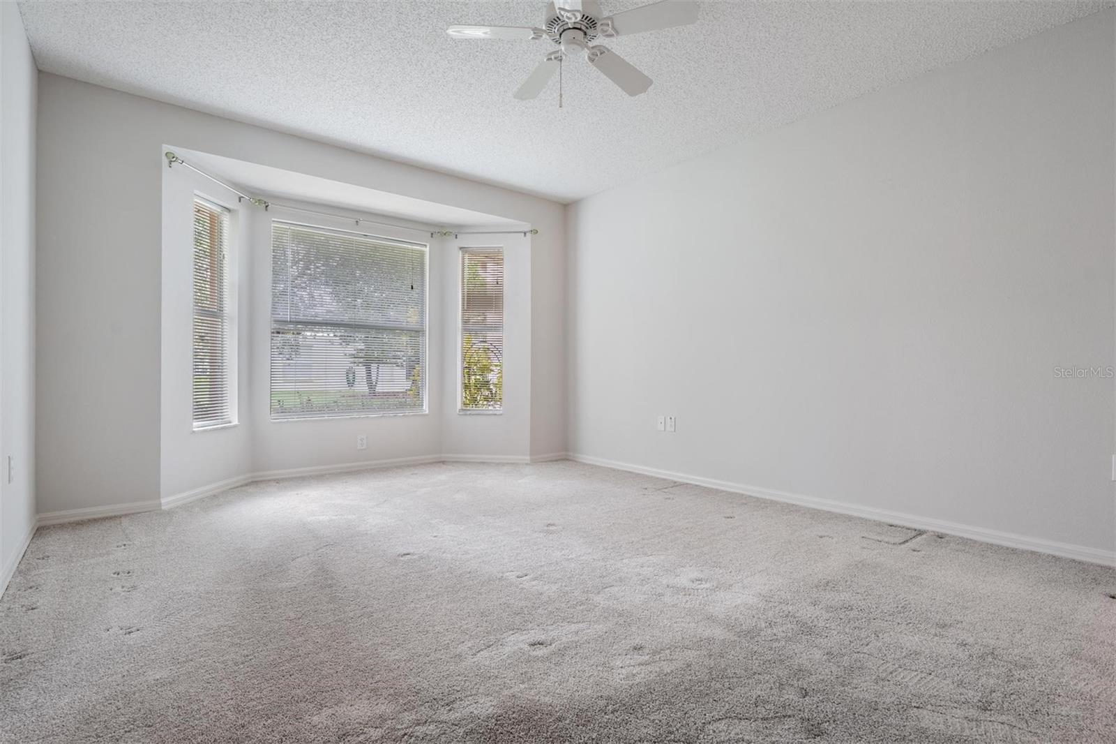 Master bedroom with a bay window