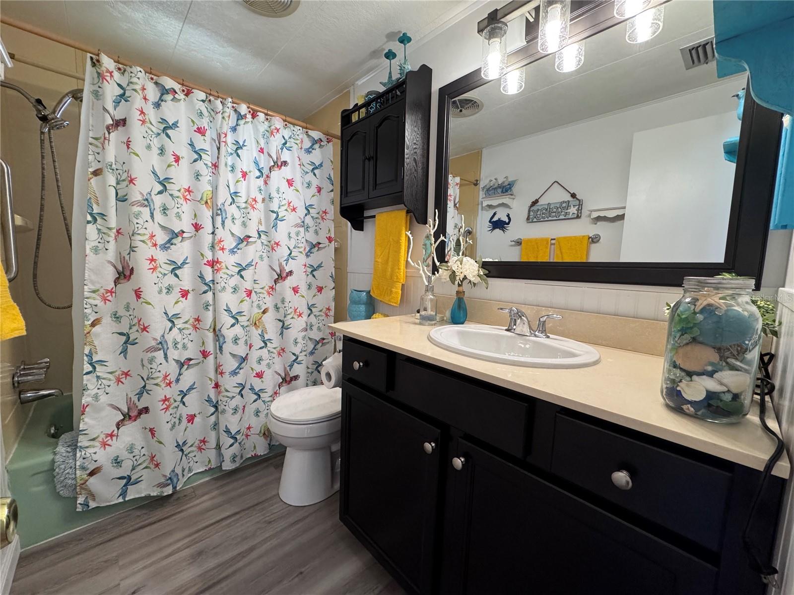 Full size bathroom with a tub shower.