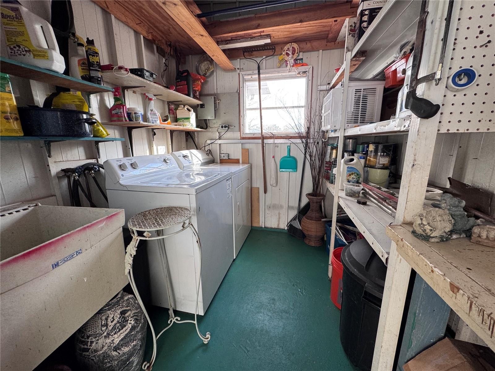 Shed has storage and washer and dryer.