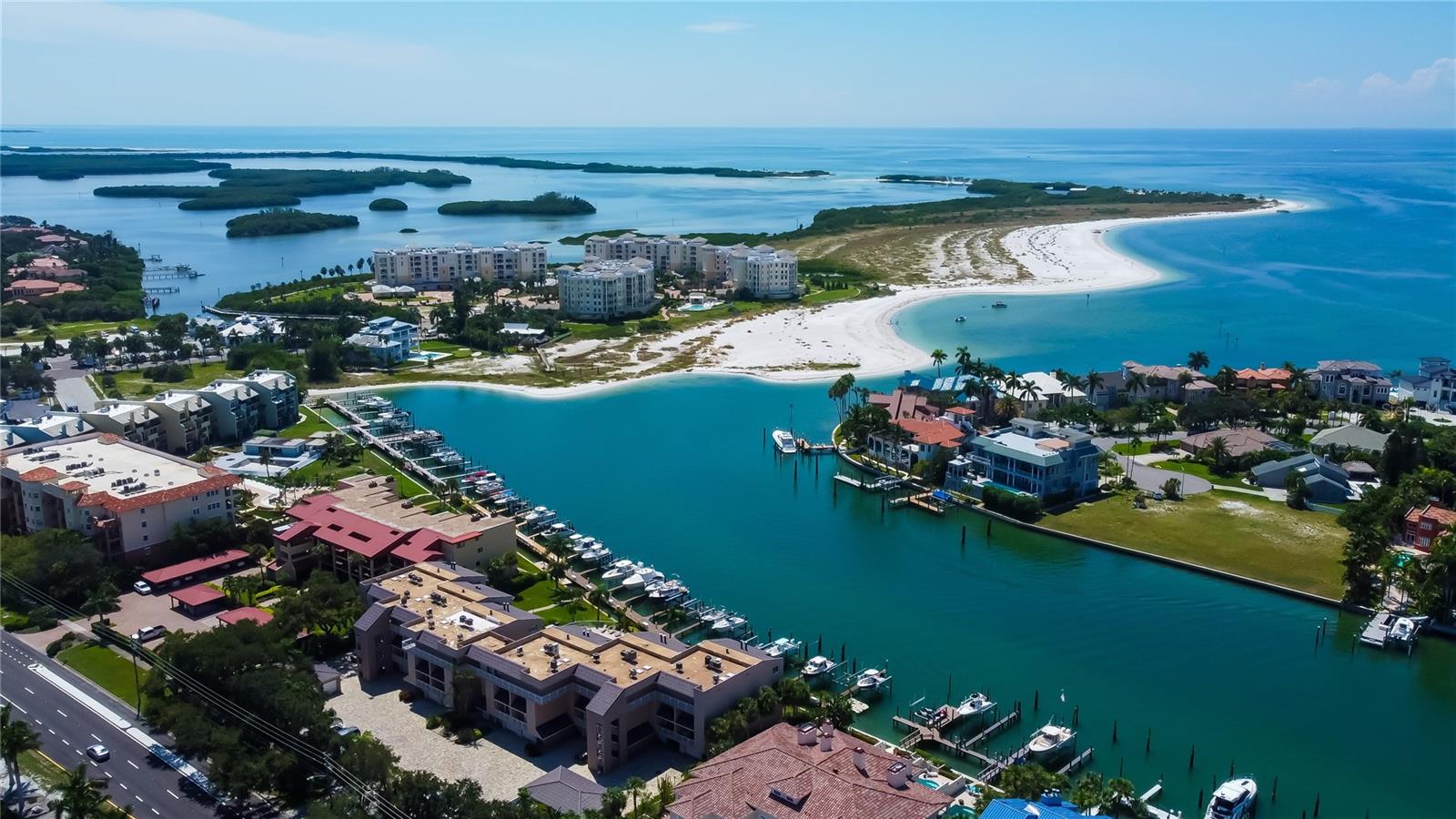 Stunning aerial view of the Grand Canal, Shell Island, and the Gulf—where turquoise waters, pristine beaches, and waterfront living create a true coastal paradise.