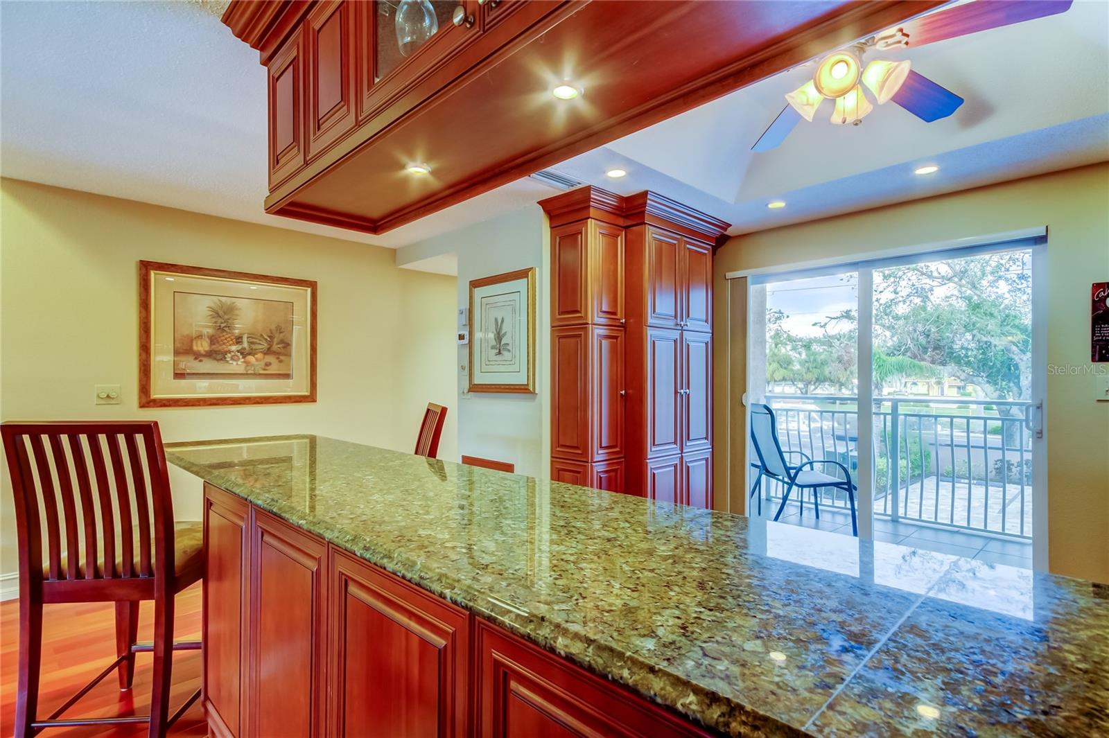 A sleek granite breakfast bar, perfect for casual dining and entertaining, overlooking the bright and airy living space.