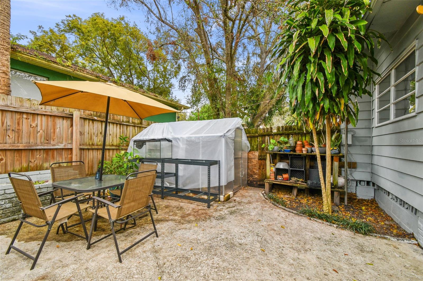 Driveway/Fenced Access to Backyard.  Greenhouse will be removed.