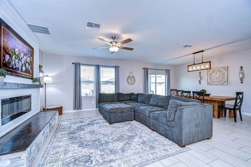 Family room with upgraded custom fireplace accented with Cypress wood hearth and mantle.