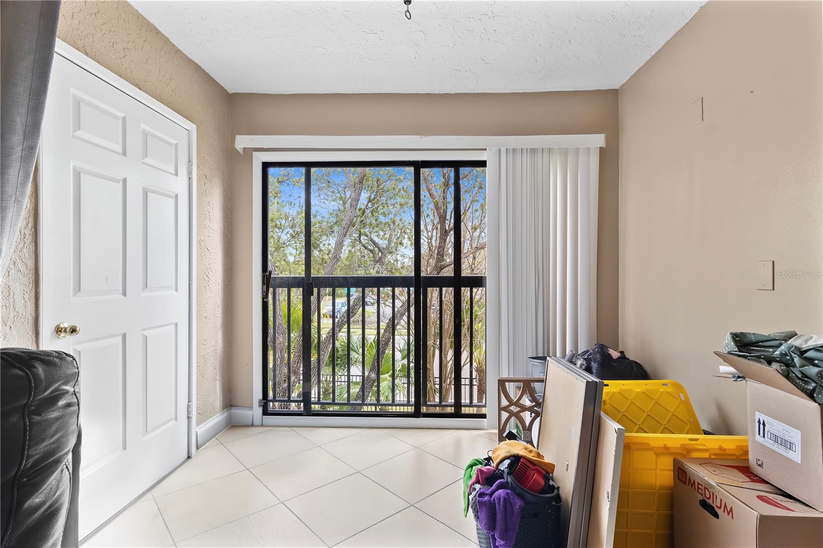 storage closet and sliding doors from living area to juliette balcony