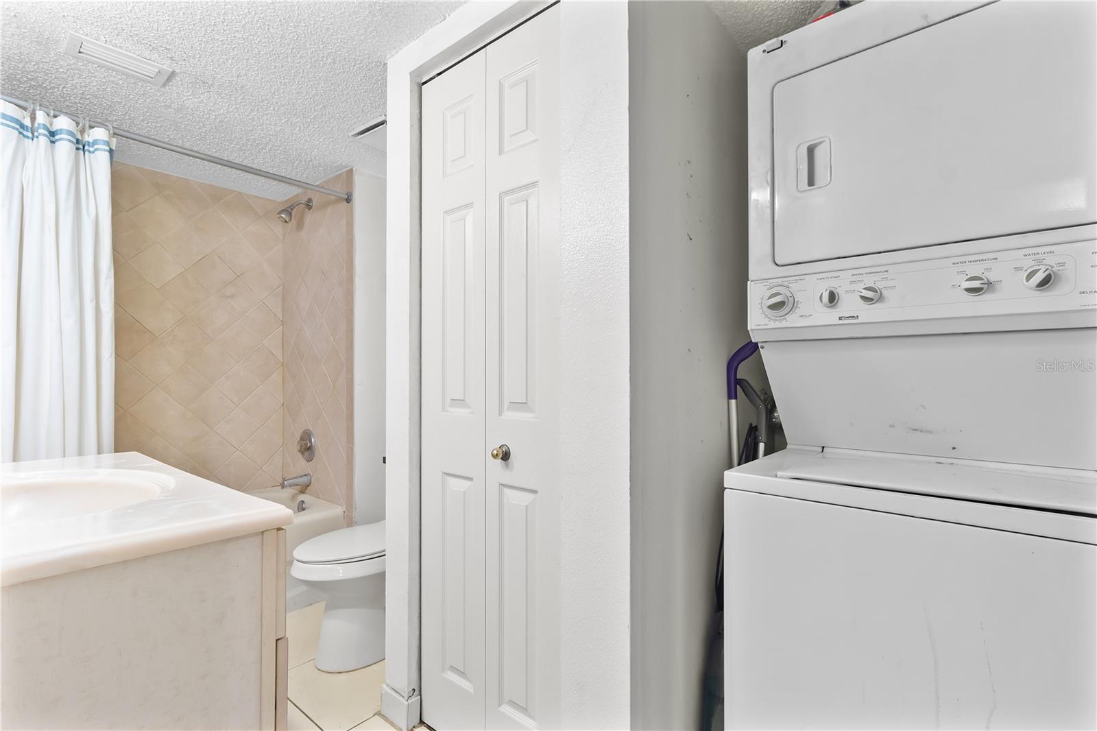 bathroom 2 with stackable washer and dryer