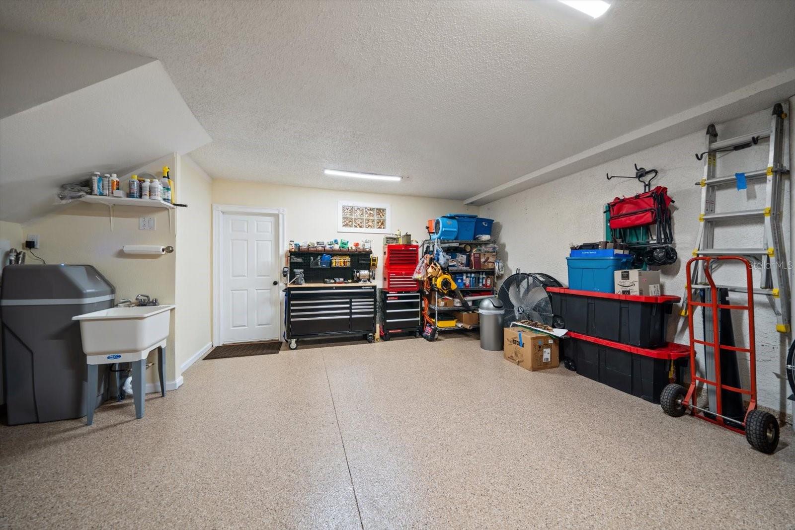 Garage with tub sink and epoxy finished floor