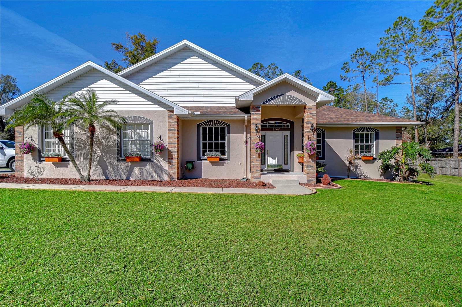 Discover serene living in this wonderful home surrounded by lush greenery.