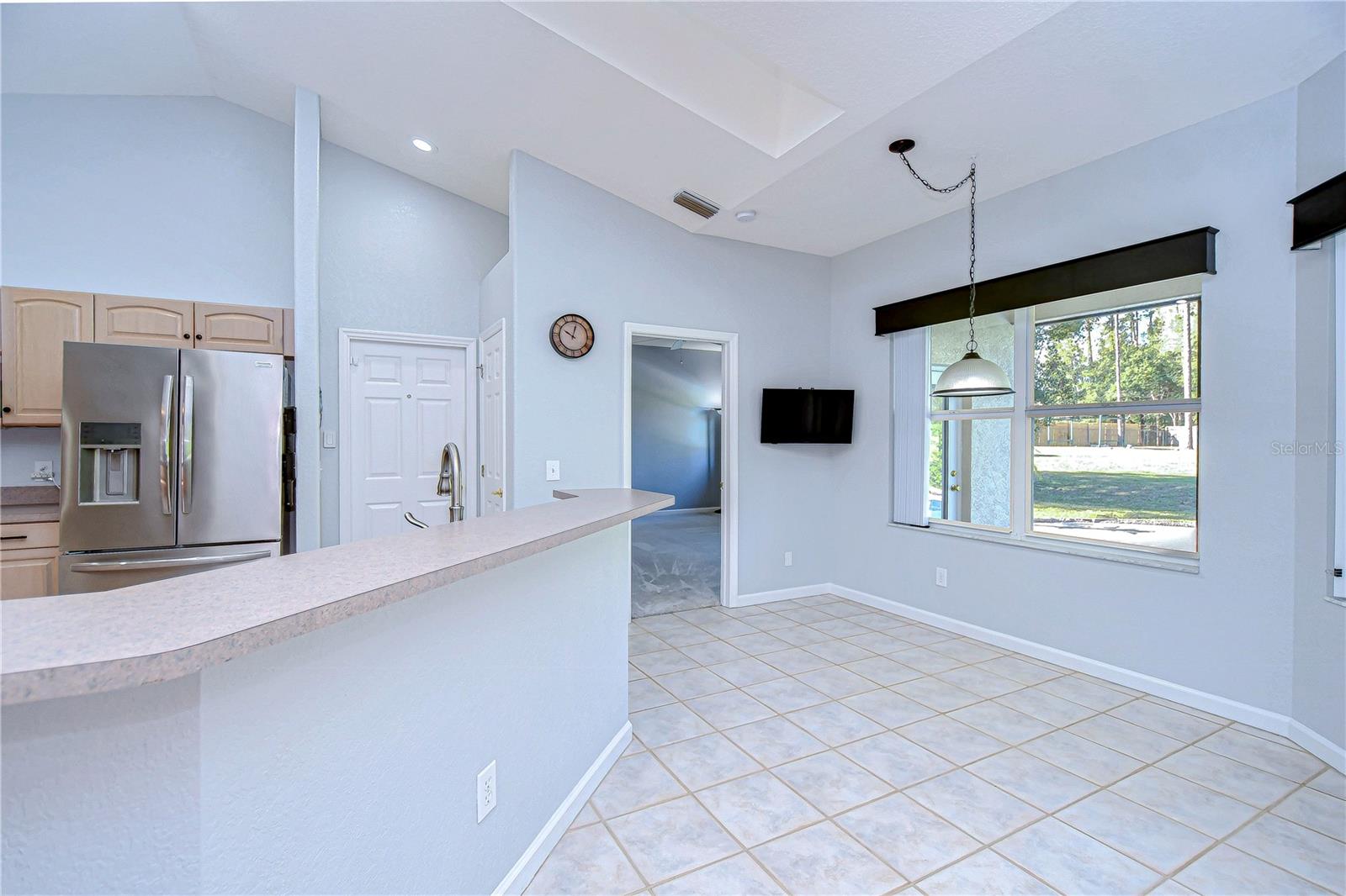 Welcome to a bright and airy kitchen-dining space, perfect for culinary creations and family gatherings.