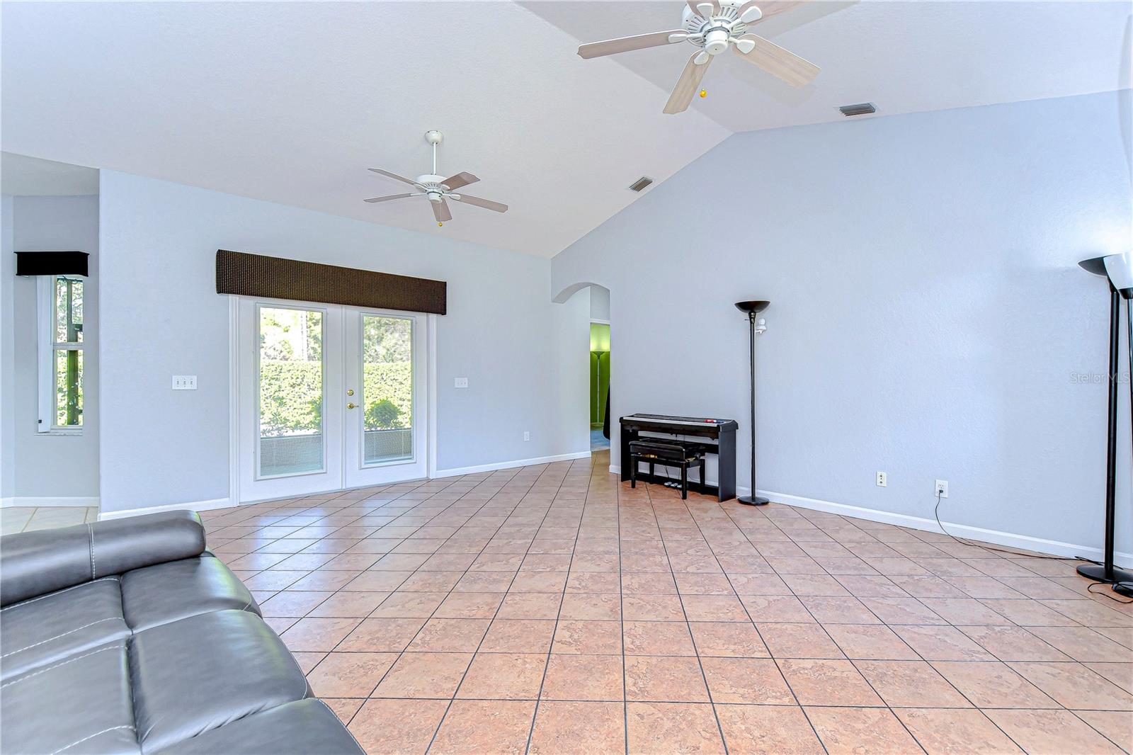 Step into this airy living space where natural light floods through elegant French doors.