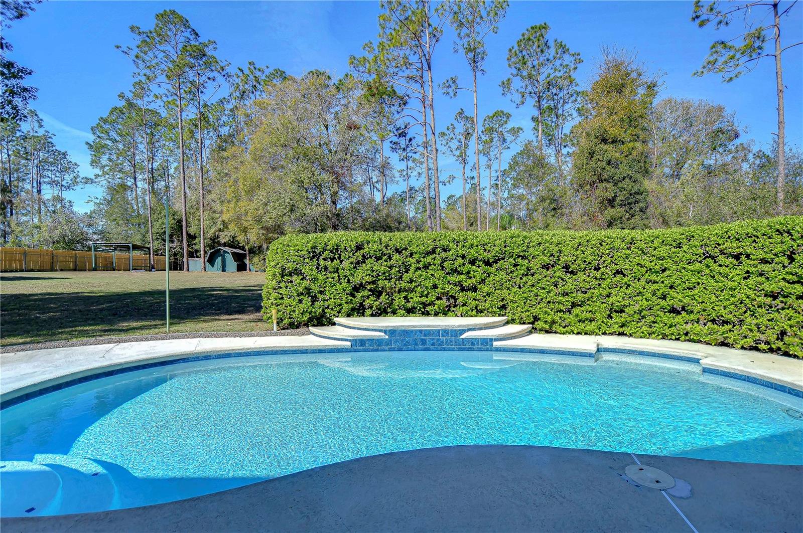 Dive into tranquility with this sparkling pool oasis