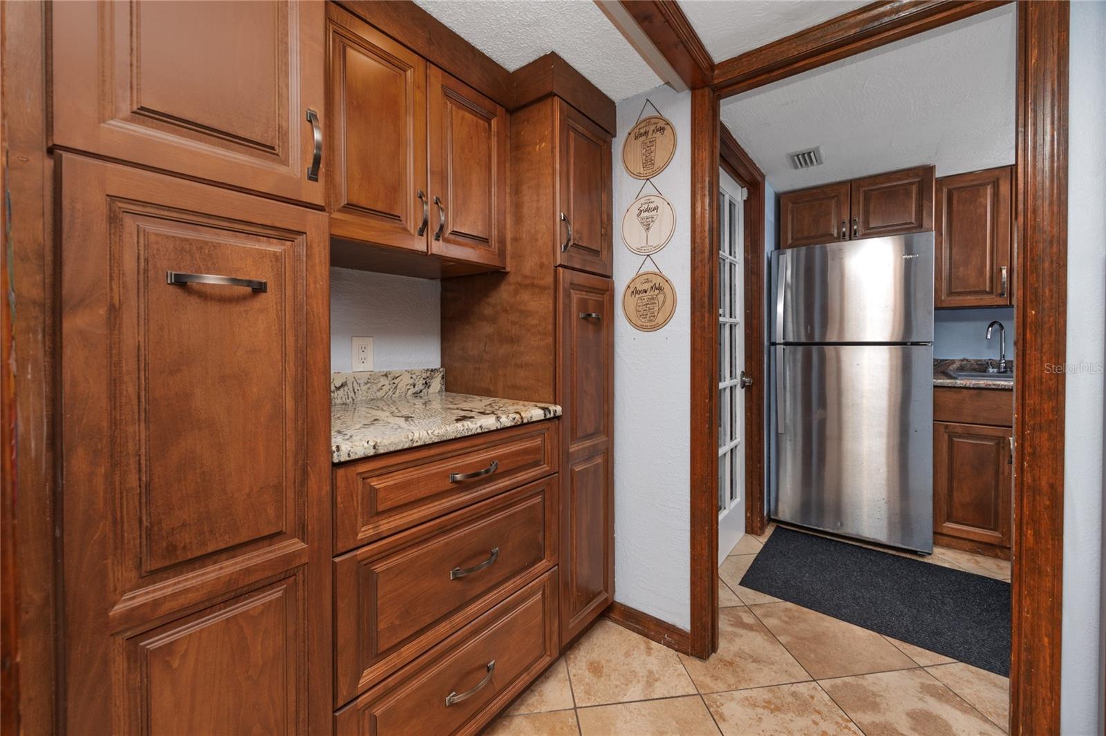 View from the kitchen towards laundry room, 2nd fridge located next to washer and dryer