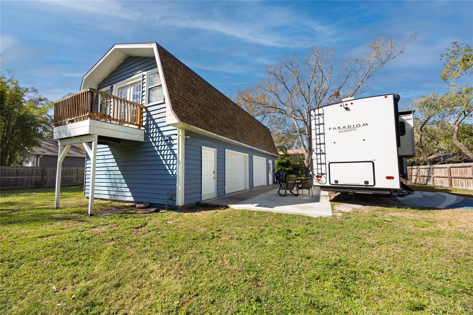 Guest house with 2 garages, one converted into an office, laundry room, full size bathroom and large apartment upstairs. Owner's RV next to the guest house.