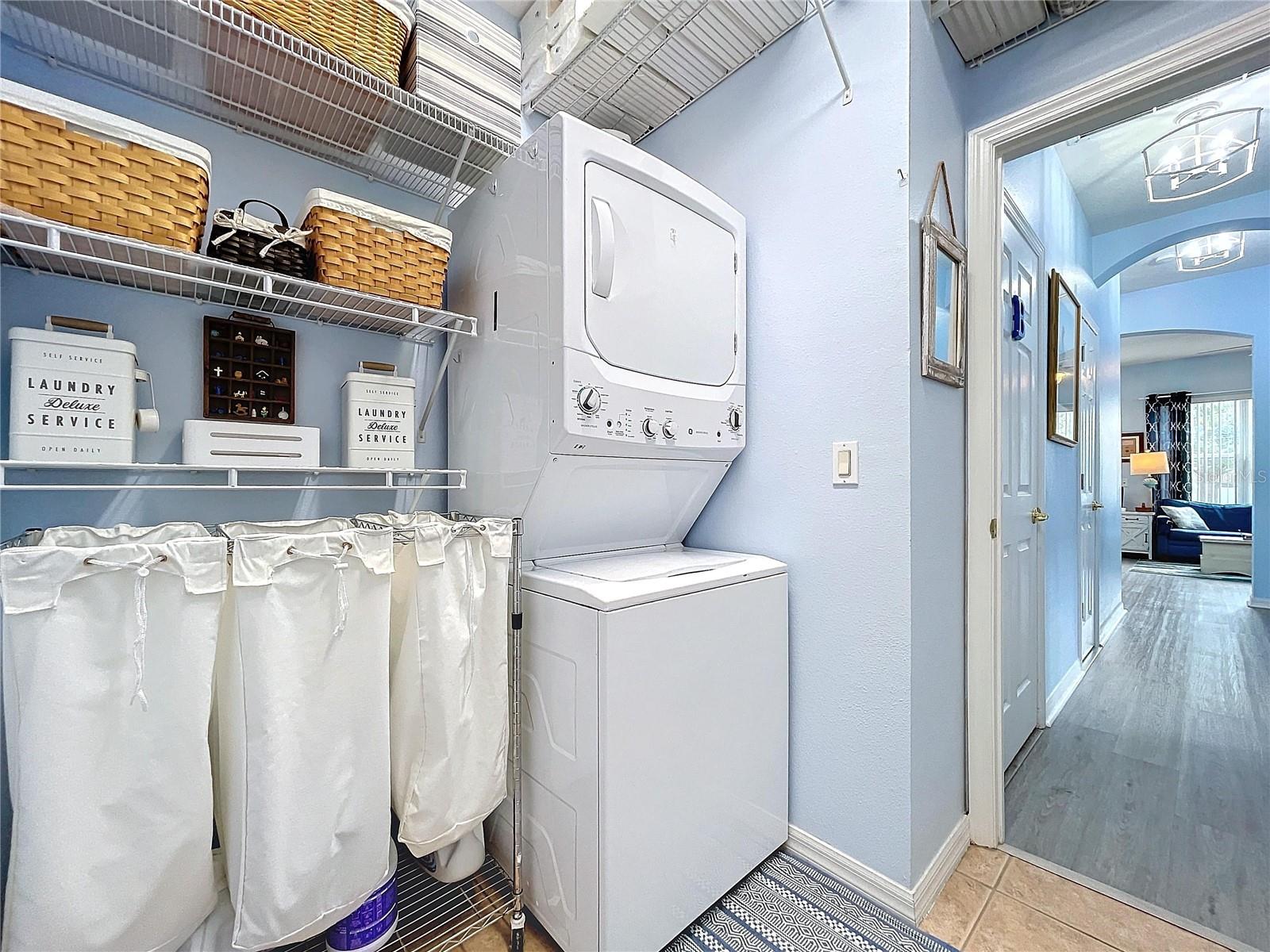 Laundry room downstairs with storage