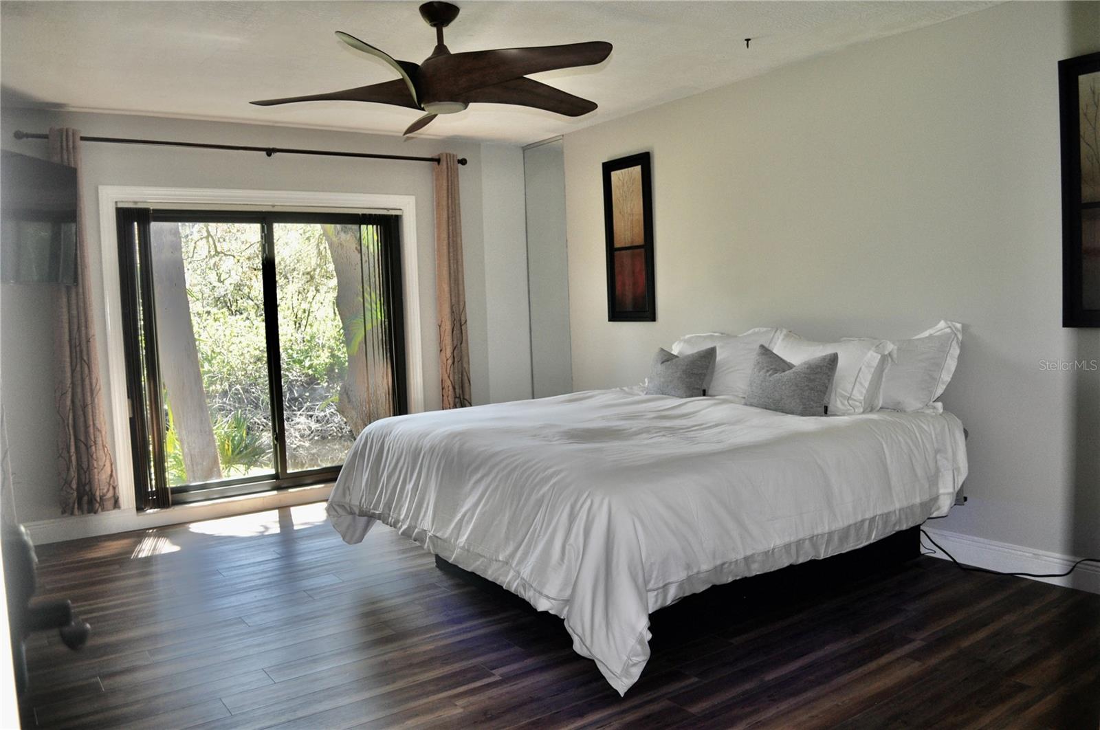 Master suite offers serene, nature -filled view.