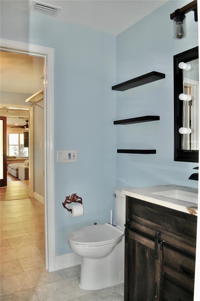 3rd bathroom serves as both stylish guest bath & convenient poolside retreat, with access also from the pool lanai.