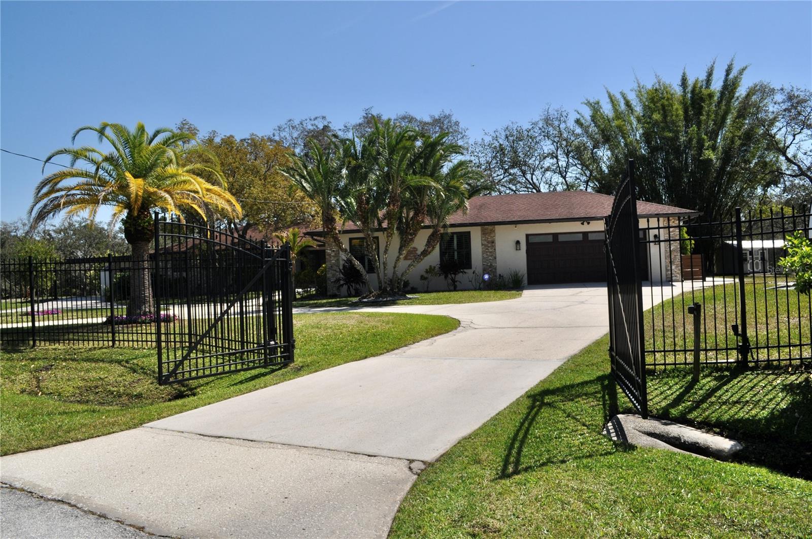 Fully enclosed secure wrought iron electric gate and perimeter fencing perfect for your furry friends allowing them to roam safely and enjoy your private retreat.