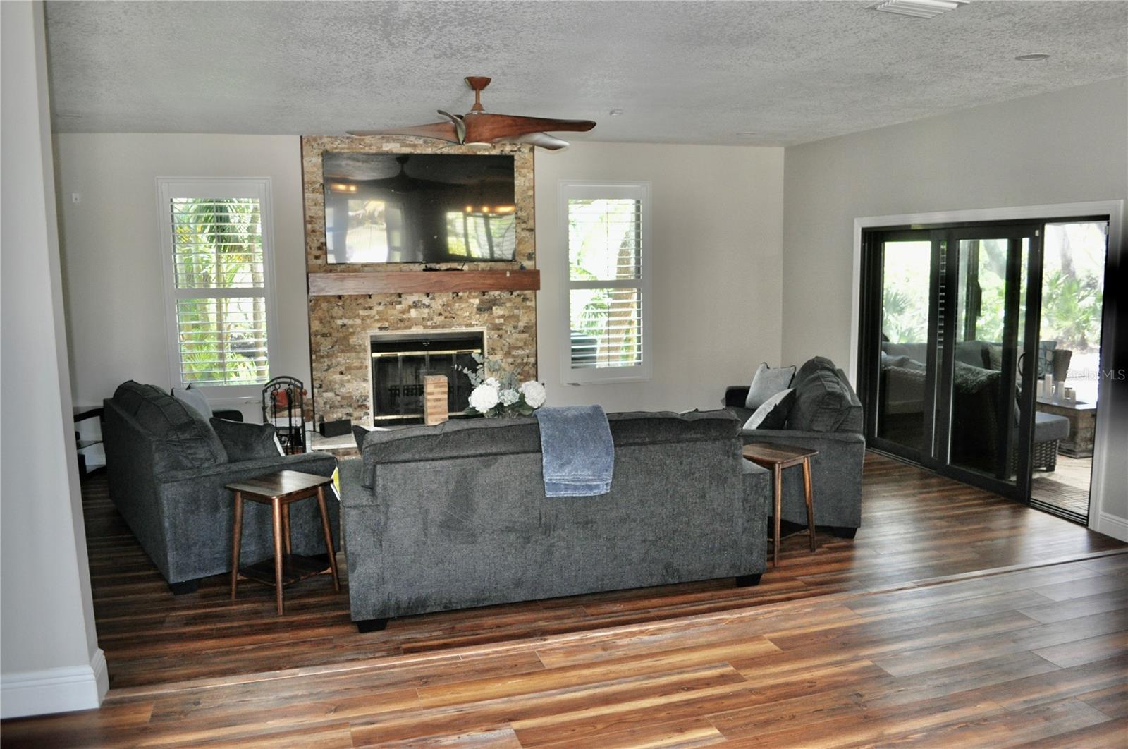 Living room w/ natural stone wood burning fireplace (chimney has been cleaned)