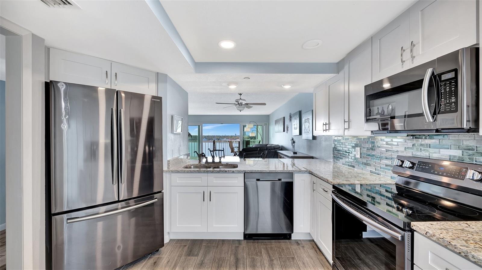 Kitchen overlooking great room to balcony