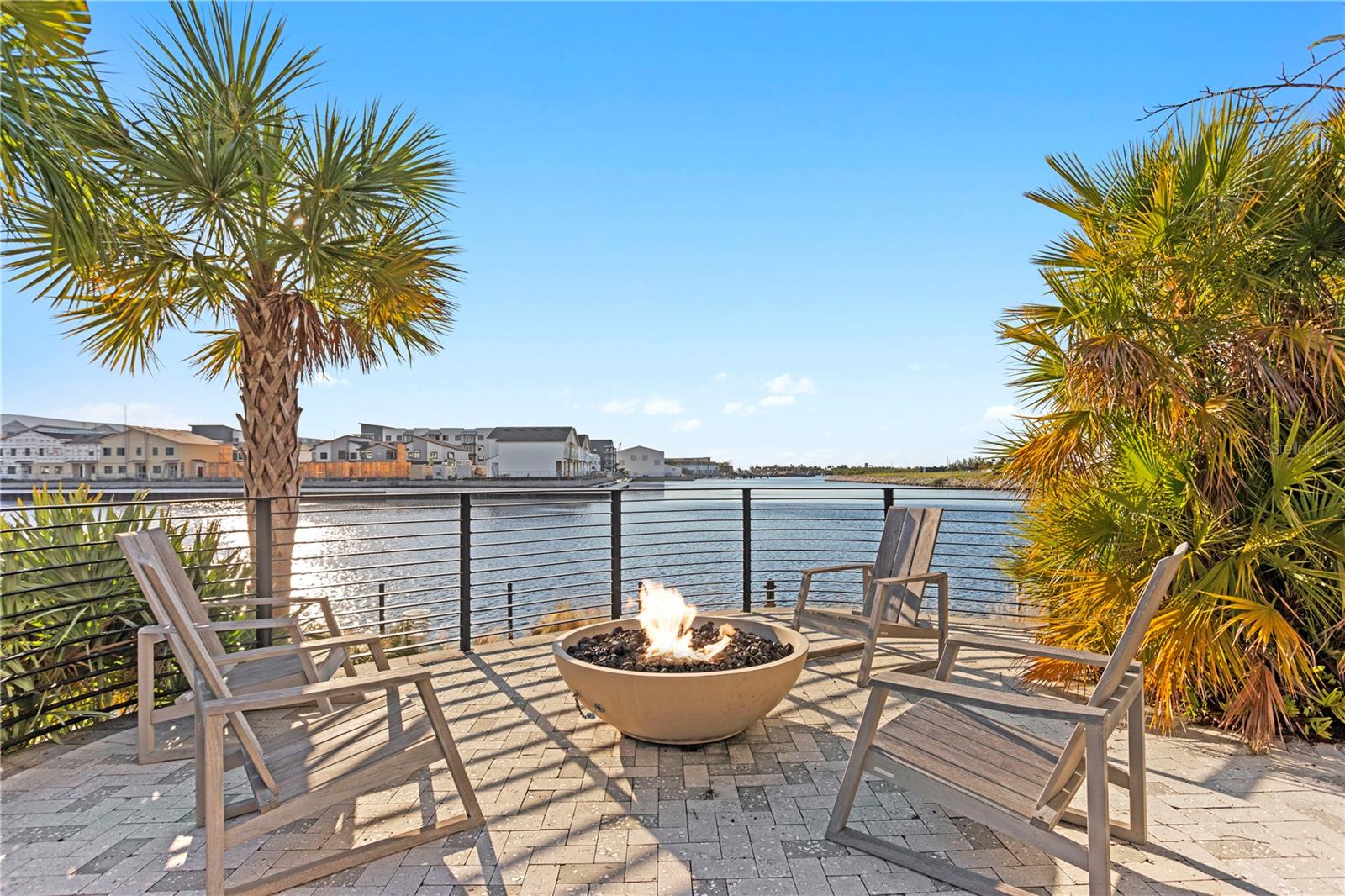 Just a few steps from the pool you have a firepit area overlooking waterfront.