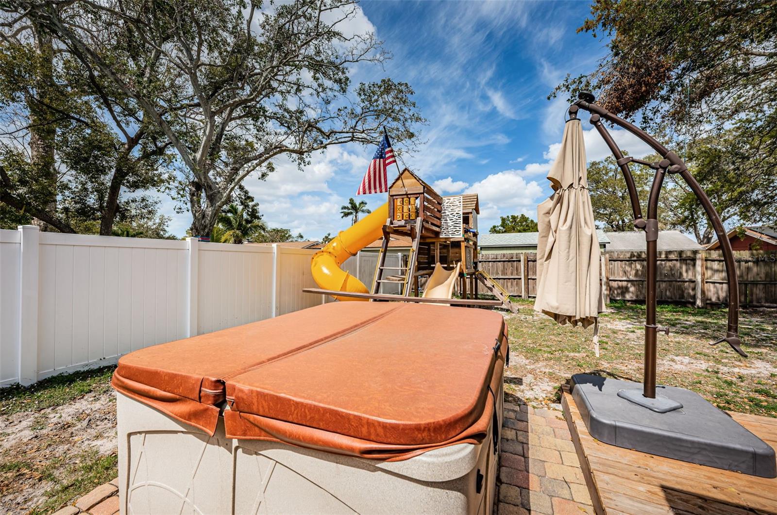 Hot tub, shade canopy and playground all come with the house