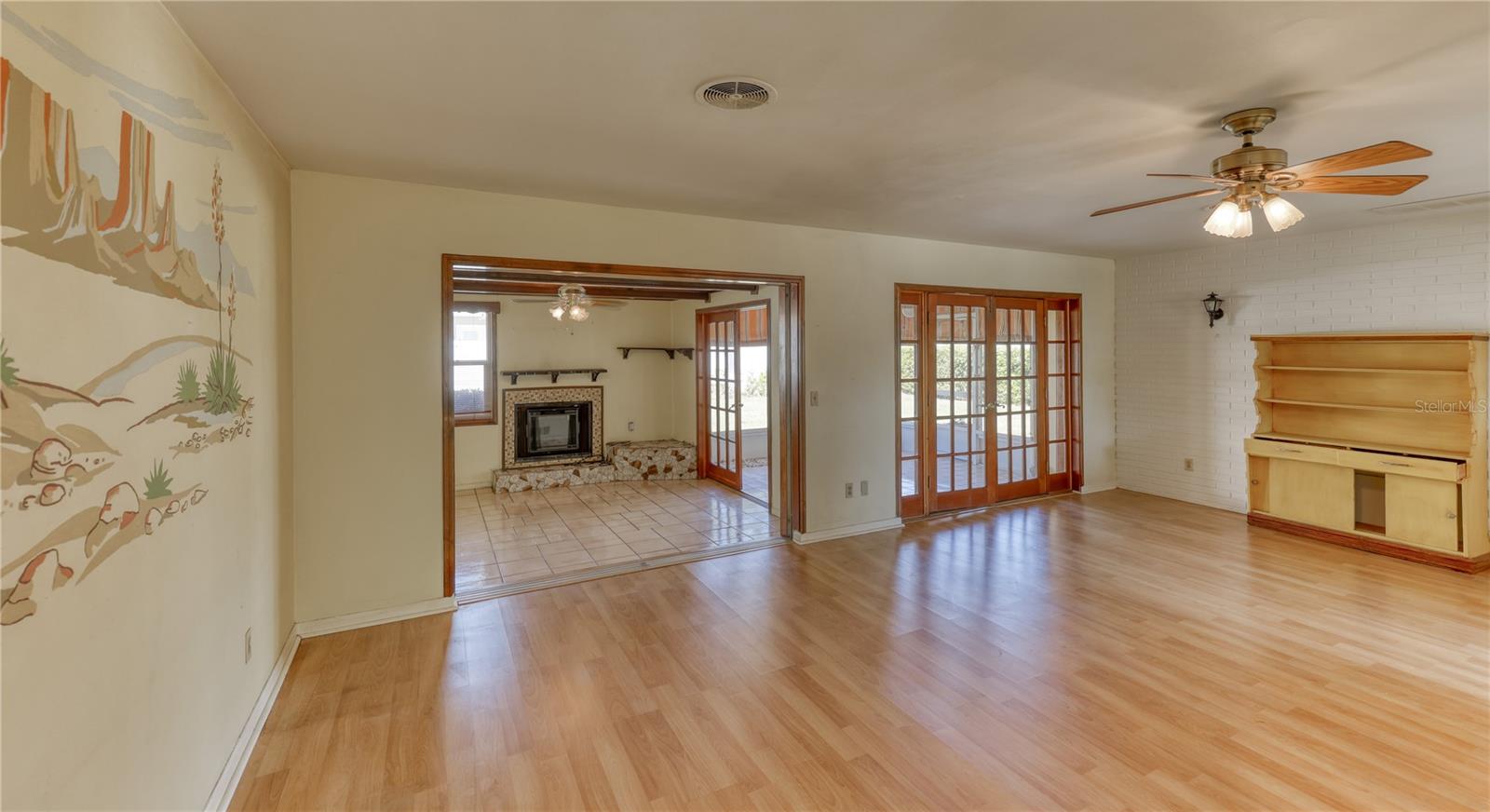 Spacious open living room with French doors