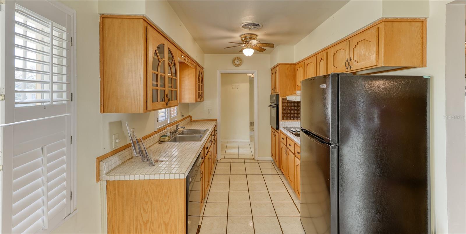 Galley kitchen with garden window.