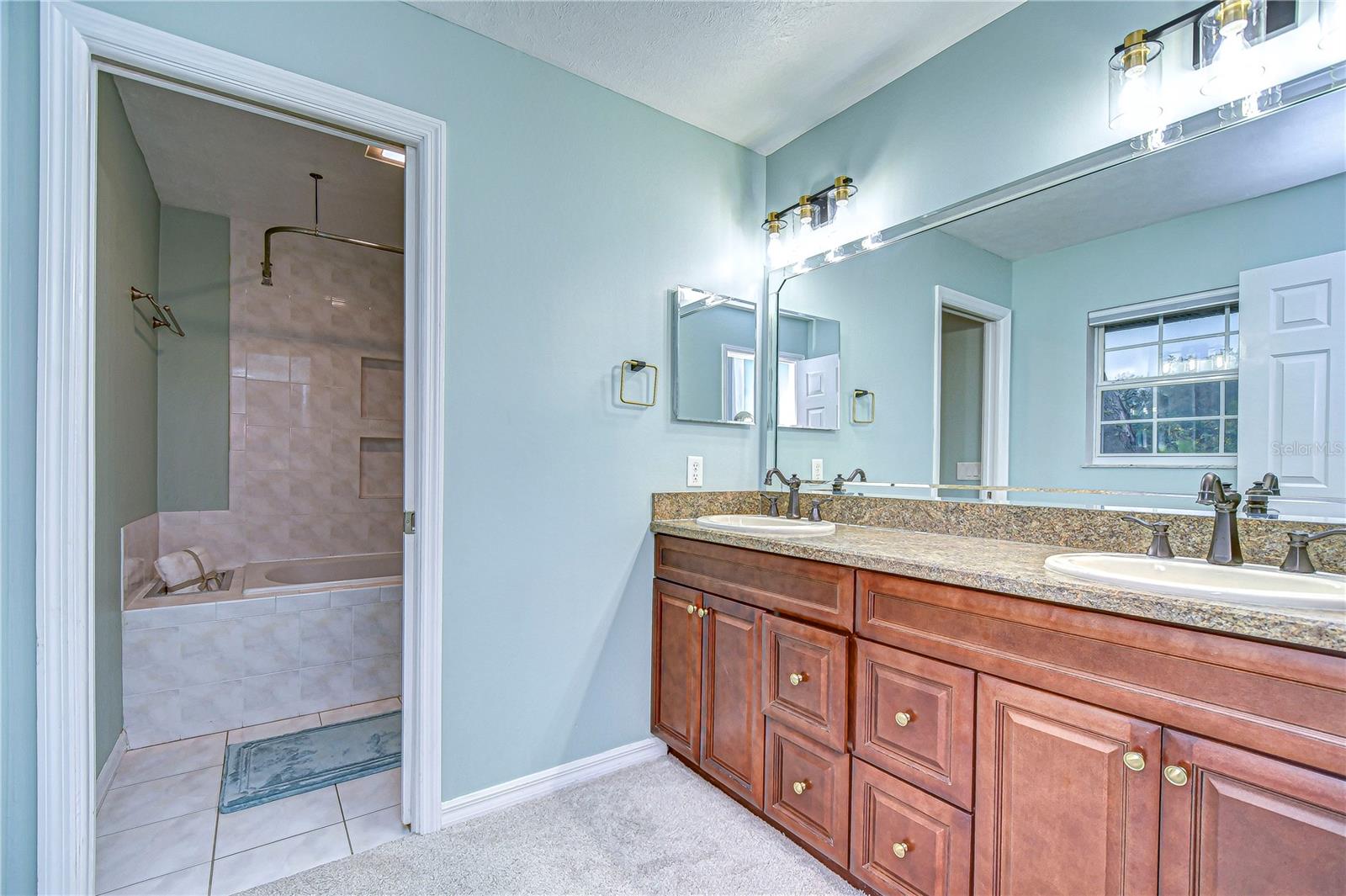 Luxuriate in the elegance of this primary bathroom, featuring a spacious dual-sink vanity.