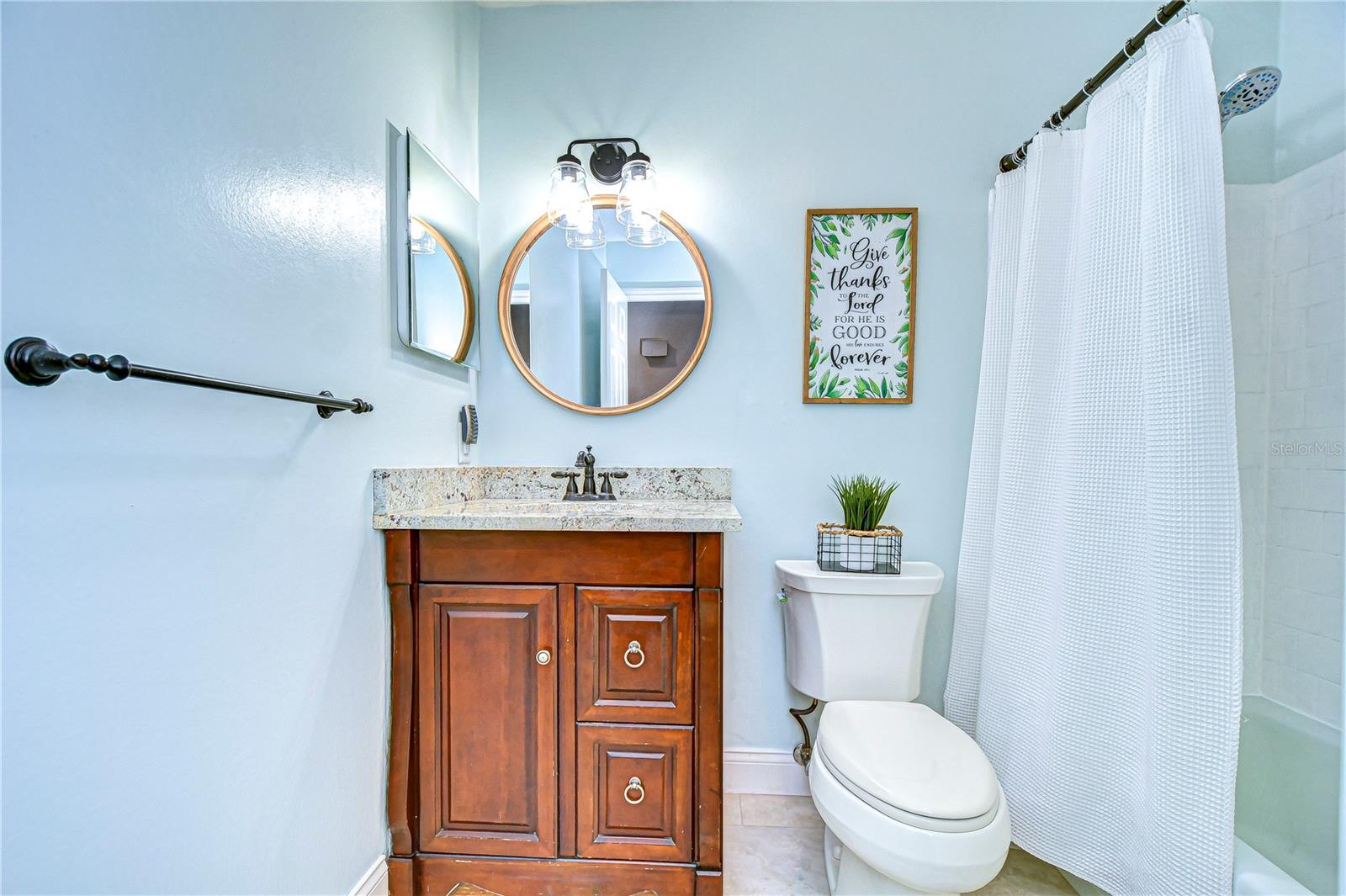 Step into serenity with this cozy bathroom haven. Enjoy the elegant wood vanity, modern fixtures, and soothing ambiance