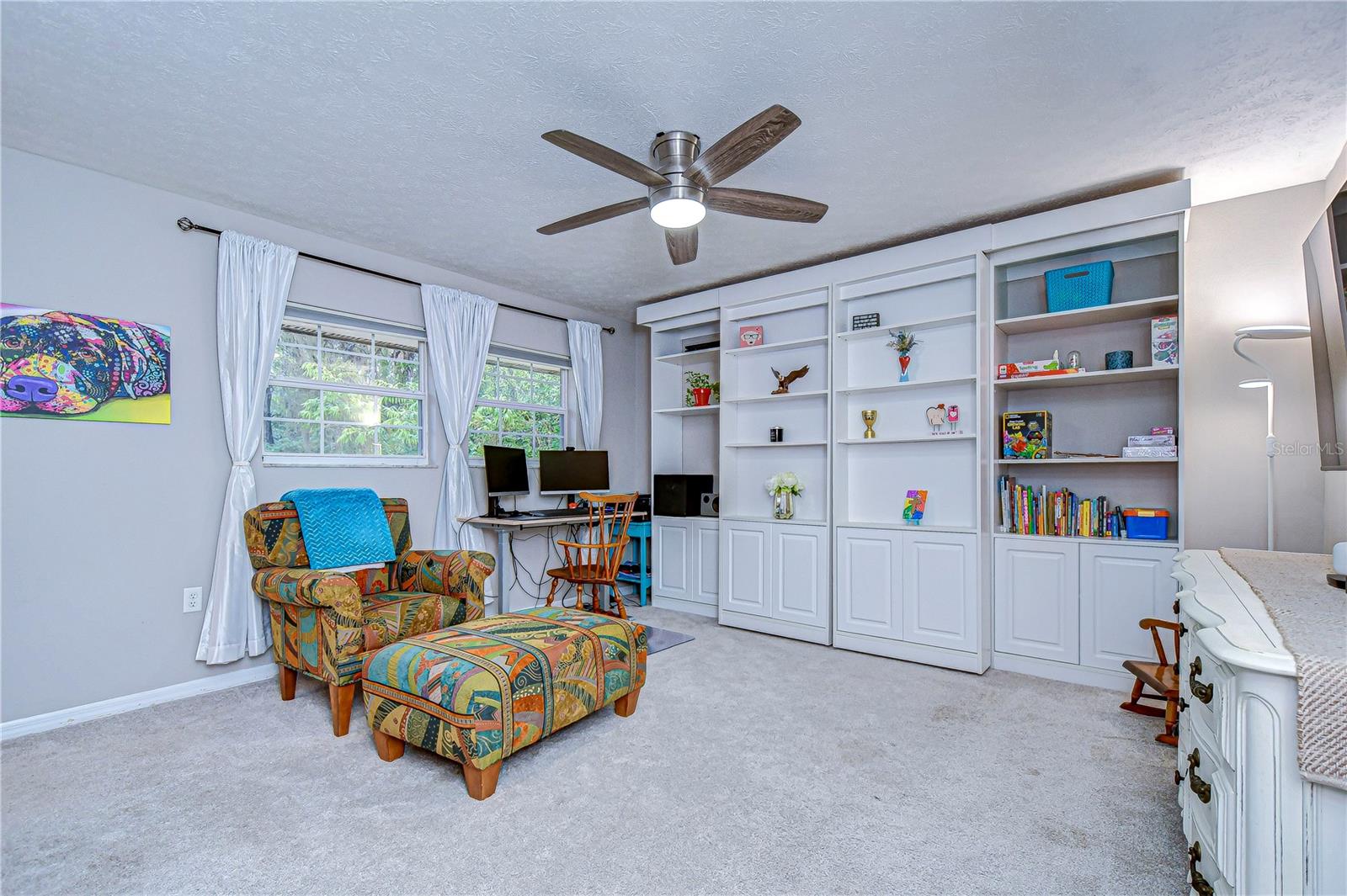 This large bonus room combines style and function with custom built-in shelving.