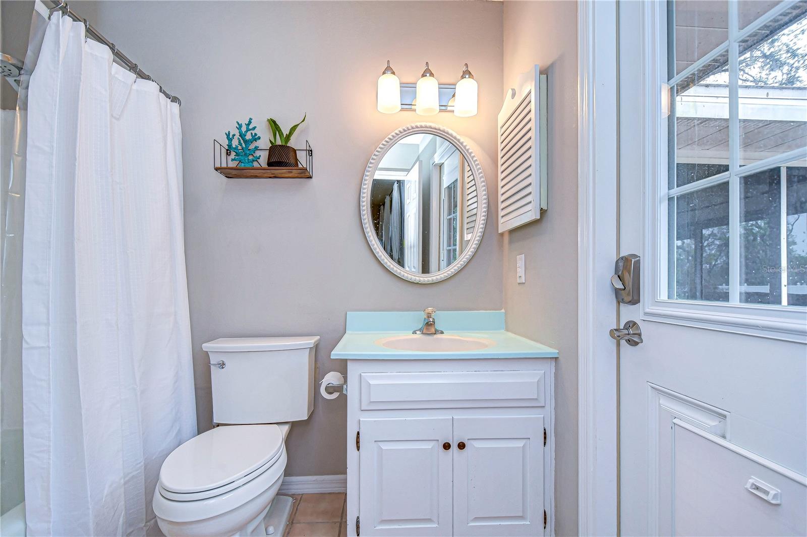 Step into serenity with this elegant bathroom, featuring a charming vanity, soft lighting, and modern fixtures.