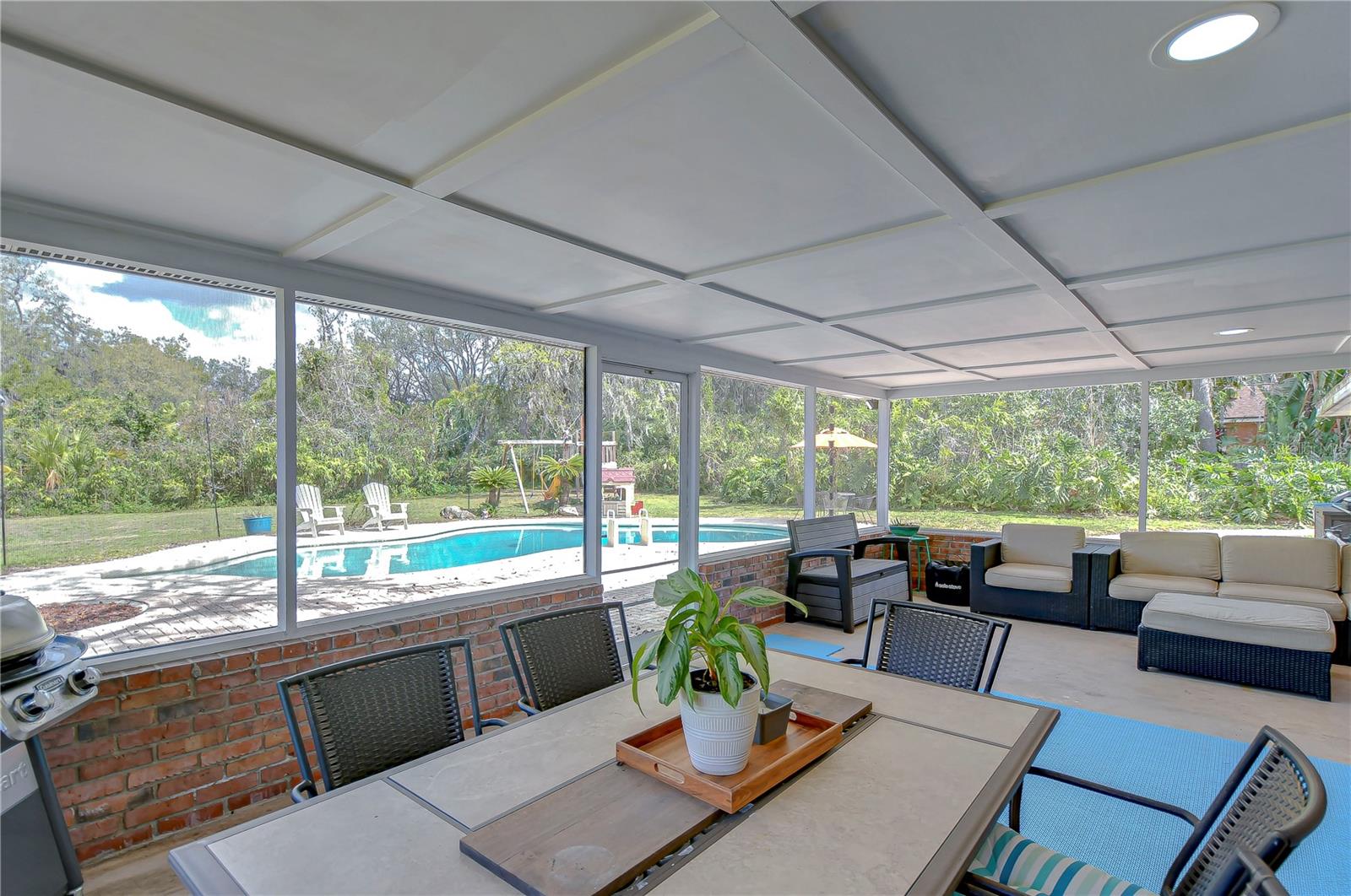 Step into your private paradise with this screened-in patio, perfect for barbeques and lazy afternoons by the sparkling pool.