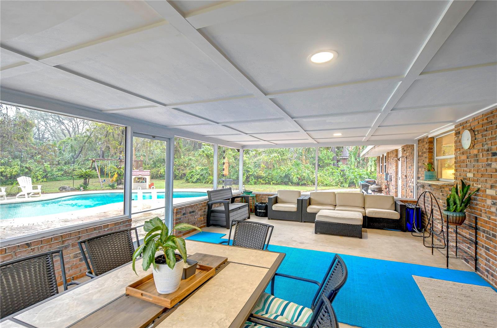 This inviting patio overlooks your private oasis, complete with a sparkling pool and lush greenery