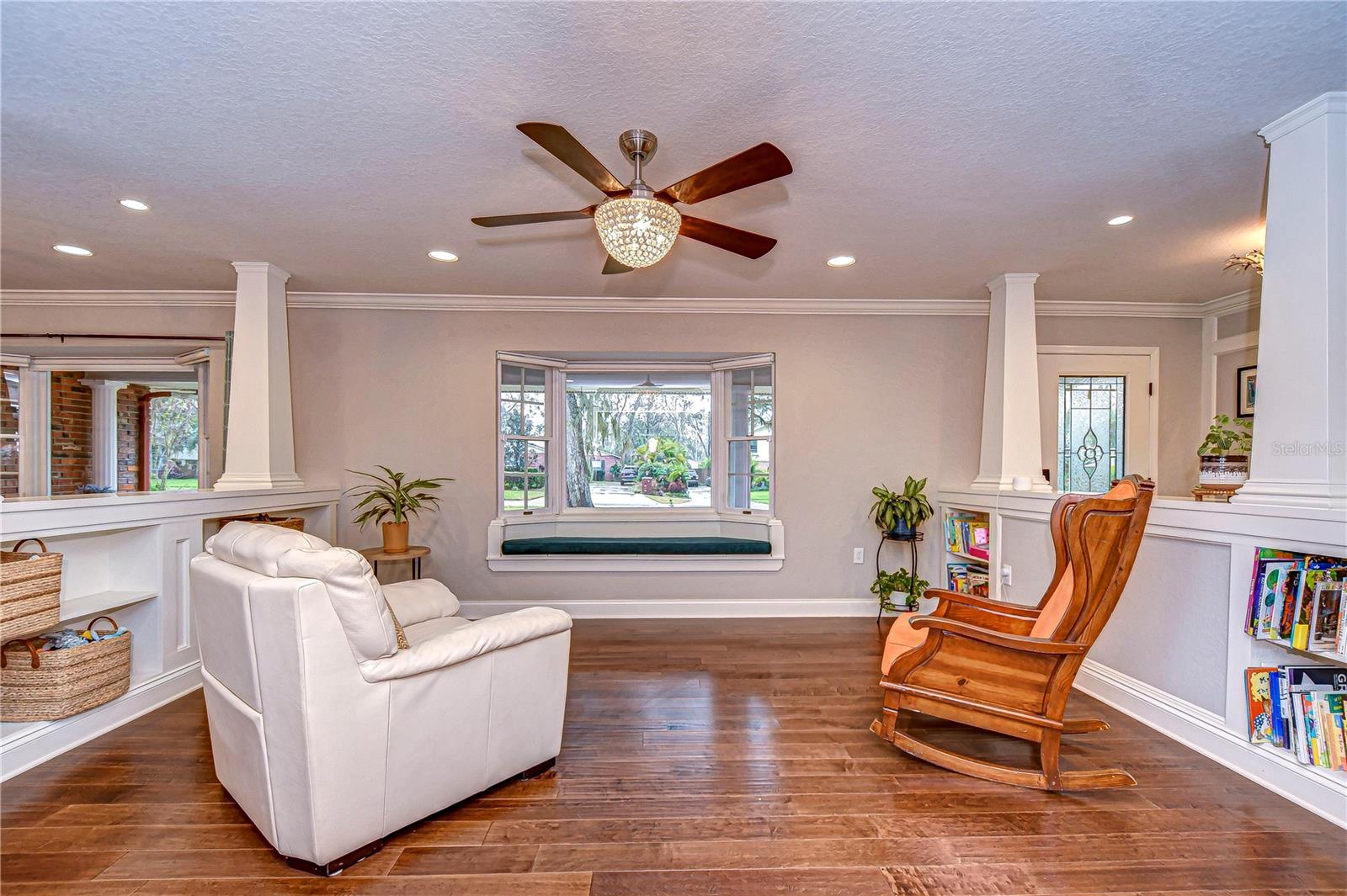 Enjoy the charming window seat for a perfect reading nook, surrounded by stylish built-in shelves.