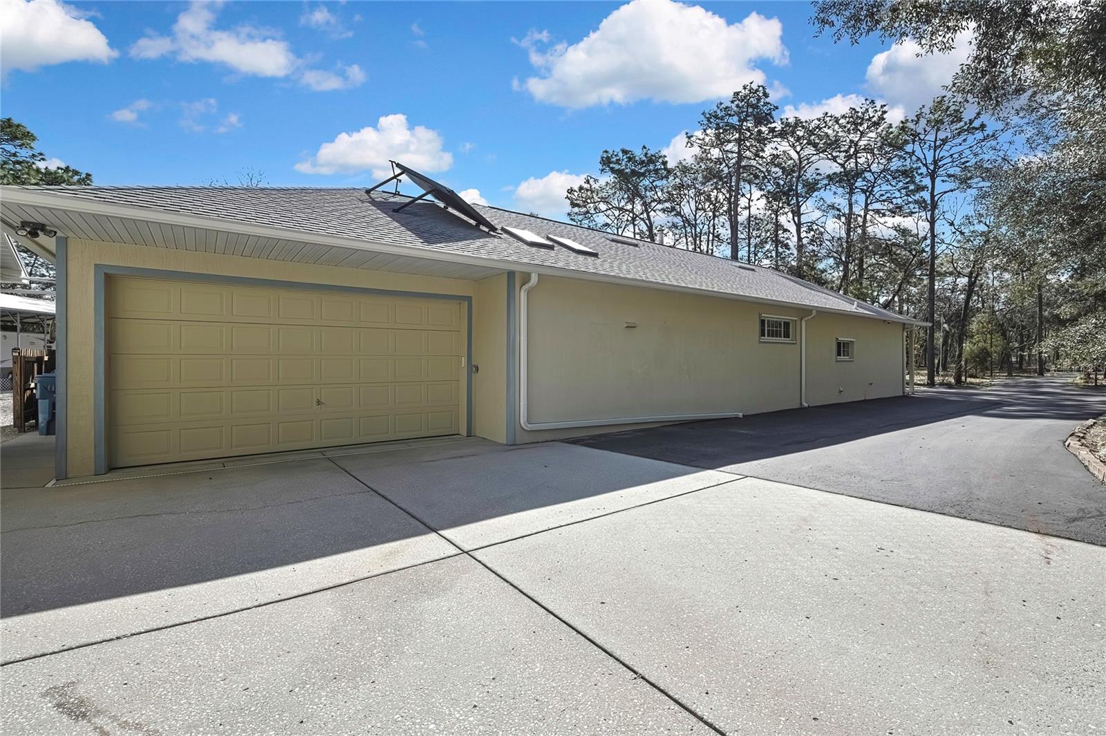 2 Car Garage Attatched to House. Solar Panel for Hot Water on Top