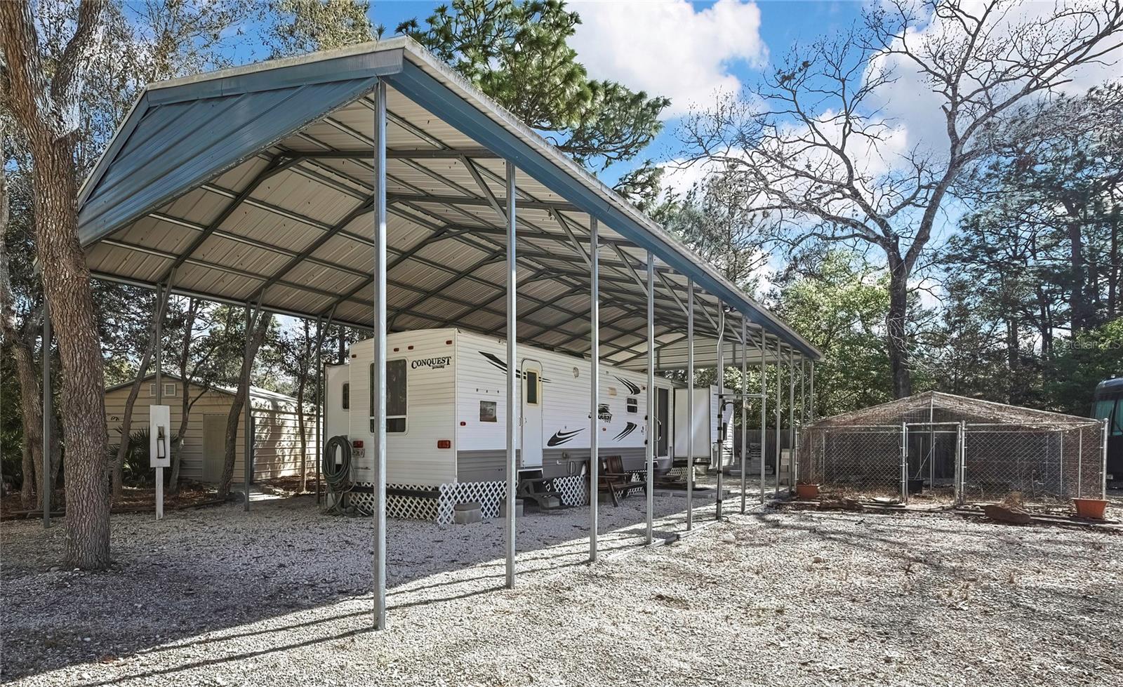 Attatched RV with own Power,  Well and Own Septic with Carport Cover. Shed # 3 Behind, and Enclosed Garden