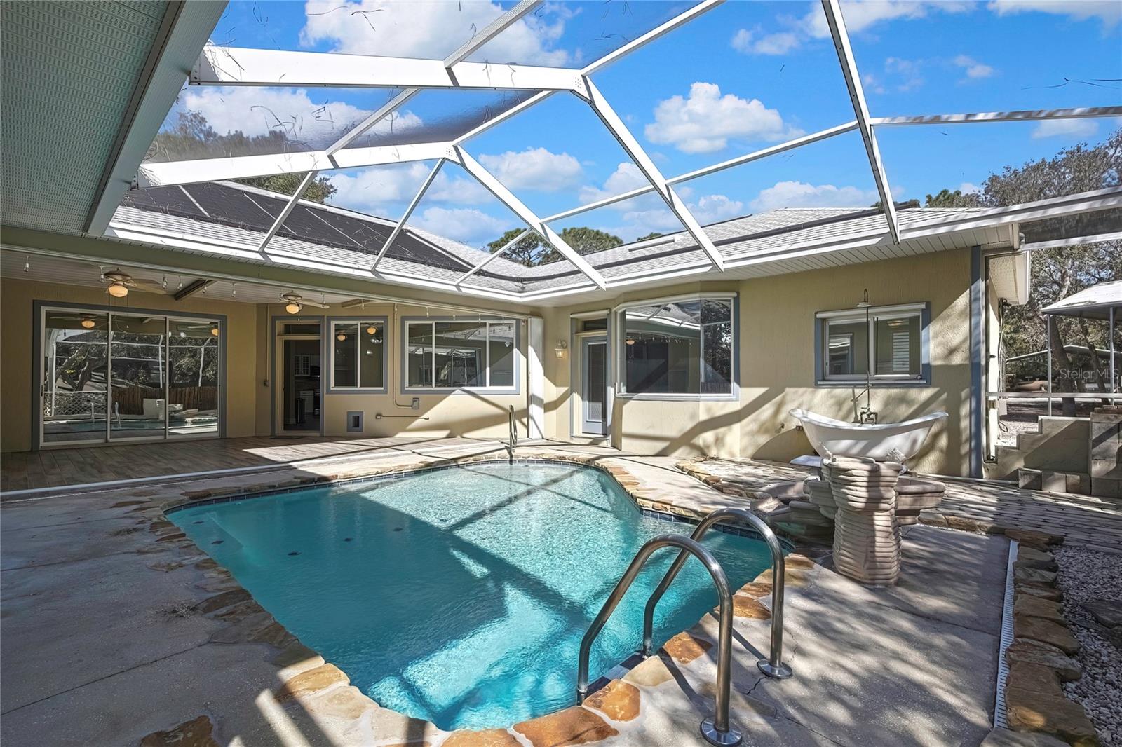 Pool Area. Right to Left- Master windows and door, office windows, kitchen door, livingroom sliders. Solar Heater for Pool.