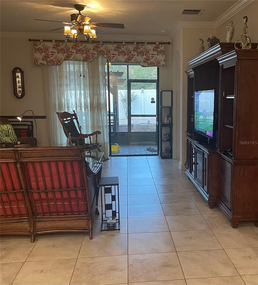 Family Room overlooking the screened back patio and papered & fully fenced back yard