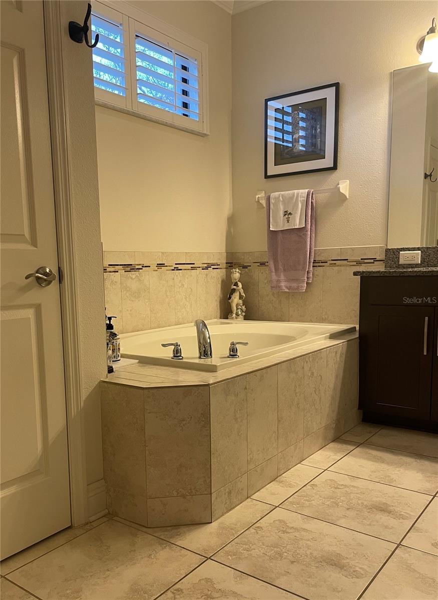 primary bathroom garden tub & custom plantation shutters