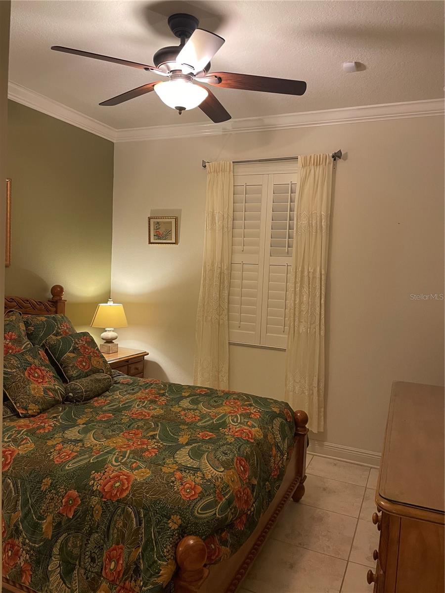 Bedroom #3, crown molding, plantation shutters, tiled floors