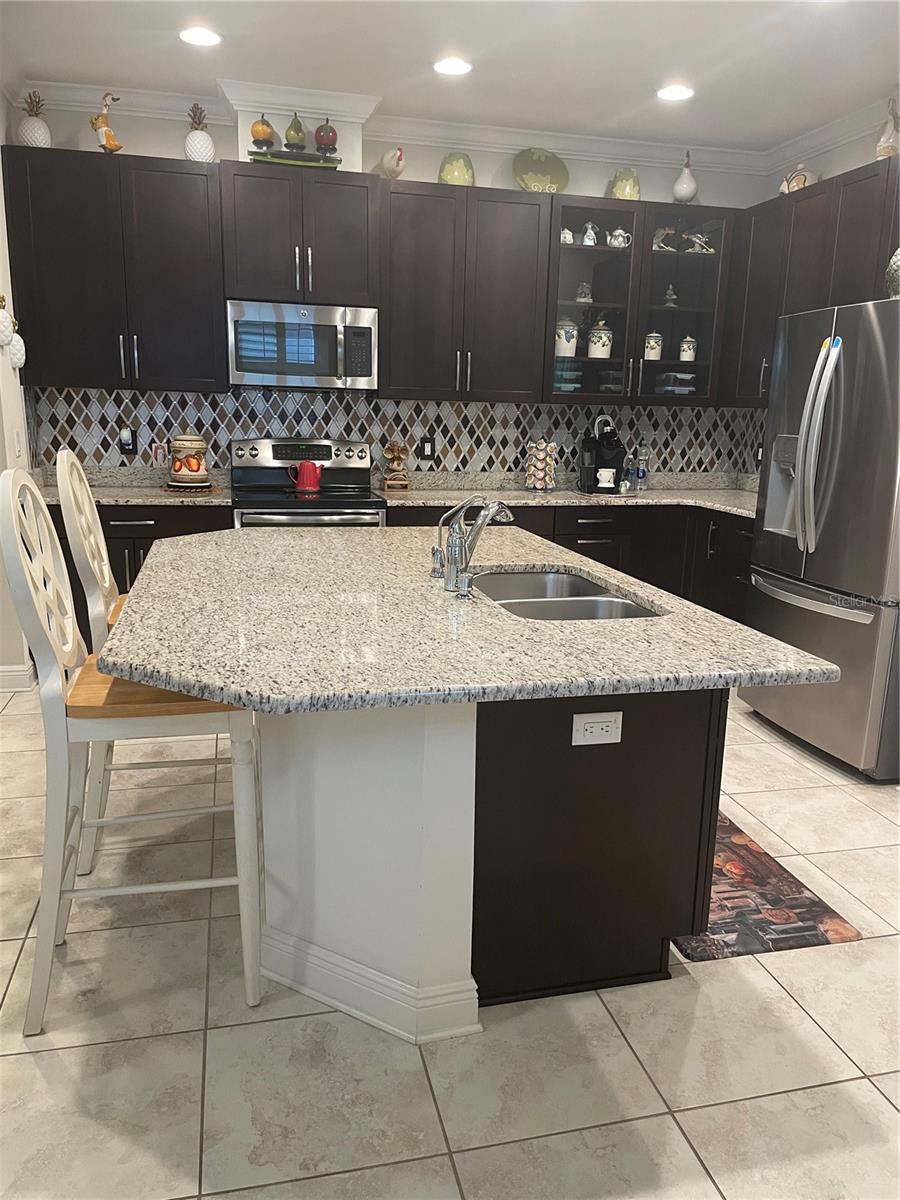 Kitchen with granite counters & backsplash